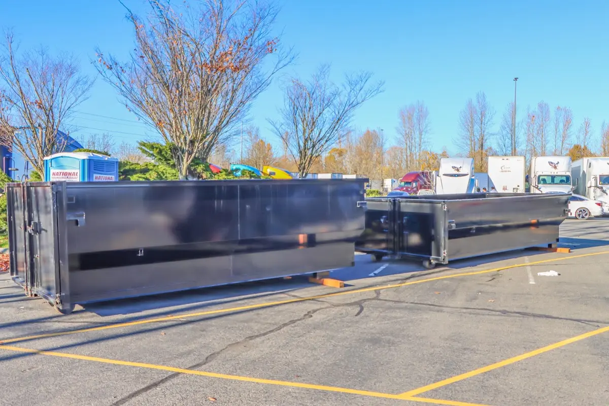 Professional dumpster rental service with roll-off container on residential driveway in Reisterstown